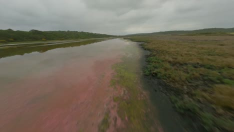 drone flying fast over a salt lake showing reflections on the water