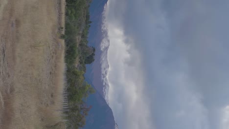 Fields-trees-and-snow-capped-mountains-in-Patagonia,-Argentina