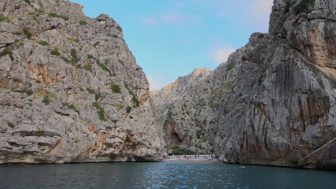 Drone shot entering the canyon of Torrent de Pareis at Sa Calobra, Mallorca, Spain coming from the Mediterranean sea during sunny day with blue skies