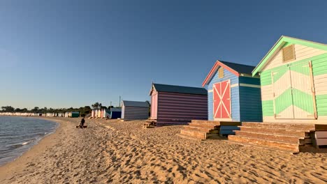 colorful beach huts with a setting sun