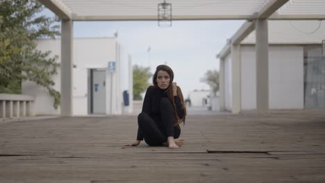 woman sitting alone on a wooden walkway