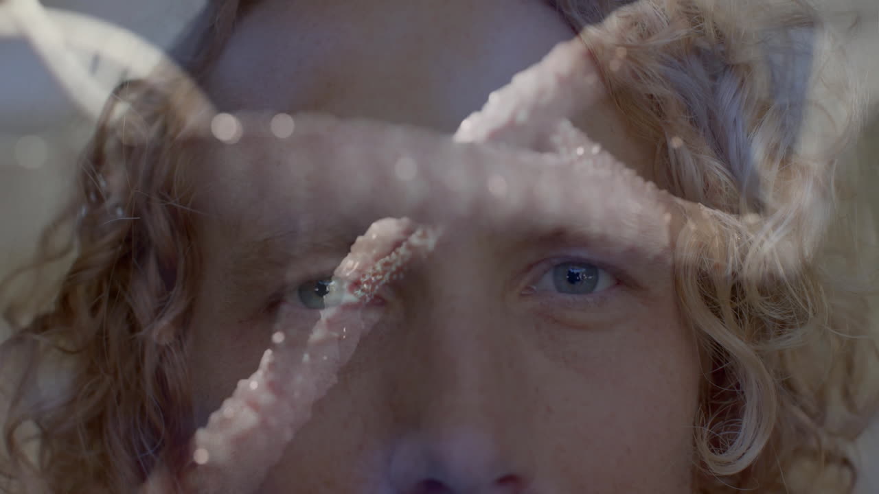 Starfish animation over close-up of person face with curly hair