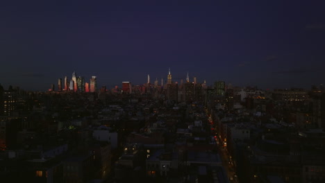 Aerial-panoramic-footage-of-evening-city.-Skyline-with-illuminated-downtown-skyscrapers.-Manhattan,-New-York-City,-USA