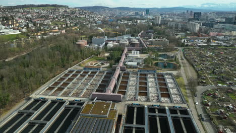 aerial drone panning shot of water treatment plant at a recyclinghof in zurich switzerland