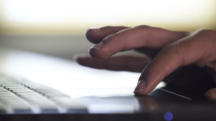 Hand using a laptop