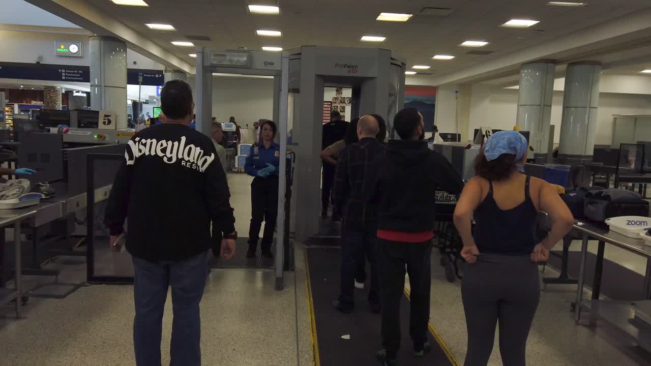 People in line to go through airport security check.