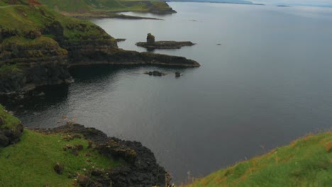 Trucking-right-while-tilting-up,-revealing-breathtaking-view-of-diverse-landscape-in-the-Northern-Ireland-coast