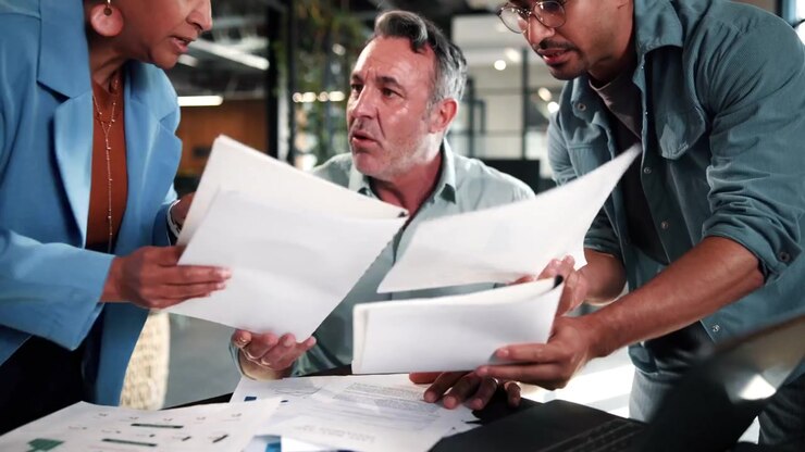 Diverse Business Team Collaborating on Financial Reports in Modern Office