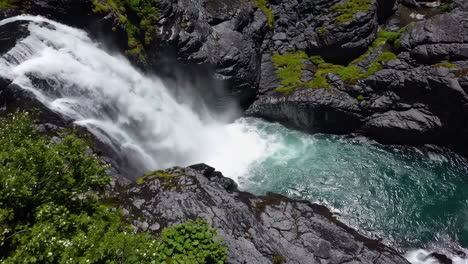 powerful waterfall cascading into a turquoise pool