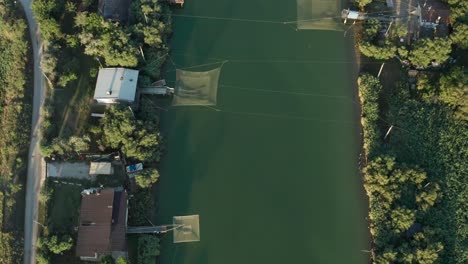 Aerial-view-of-fishing-huts-in-the-river,-Lido-di-Dante,-Fiumi-Uniti,-Ravenna-near-Comacchio-valley