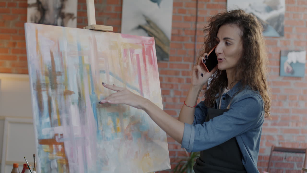 Artist Talking on Phone in Art Studio