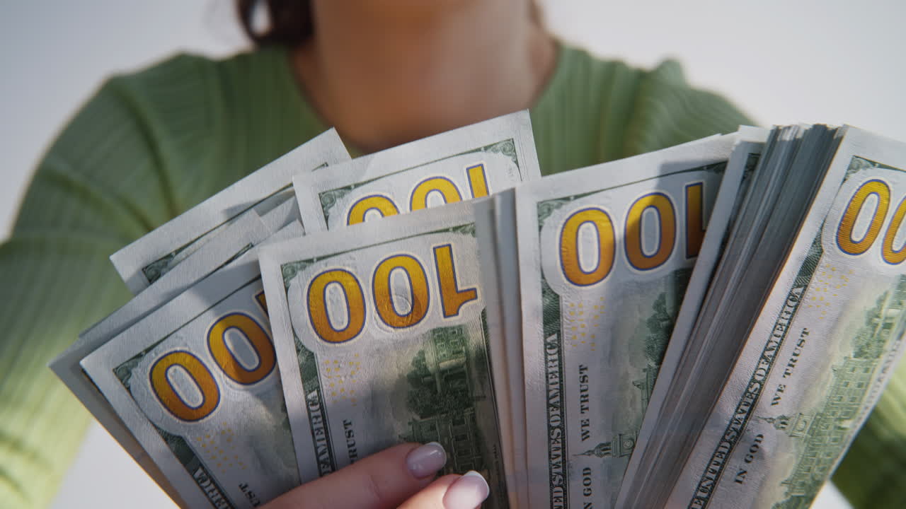 Unknown woman holding dollar bills pack closeup. Businesswoman counting currency