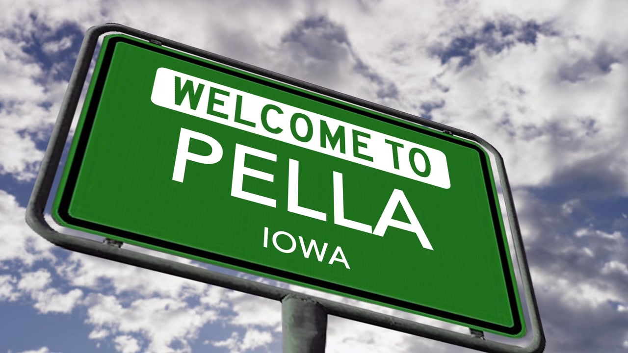 Benvenuti a Pella, Iowa, USA. Cartello stradale della città in primo piano, animazione 3D realistica