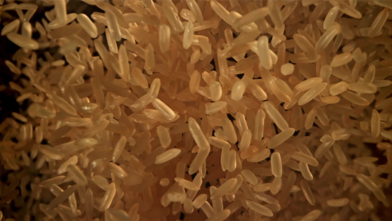 Slow Motion Close Up of Raw Rice Grains Pouring
