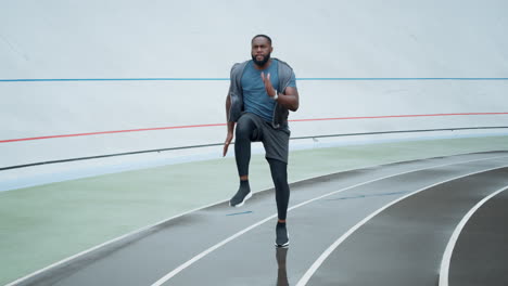 guy training on stadium track