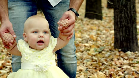 young father for a walk in a autumn park with baby