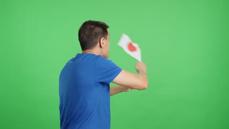 Rear view of a man waving a japanese pennant