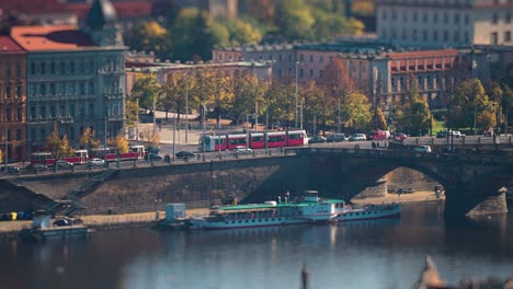 cars, trams, busses rush along the vltava river embankment