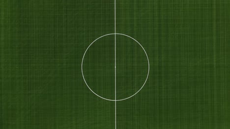 Top aerial view of soccer (football) field. Drone flying away from empty sports recreational field. Zooming out of the University of Wisconsin–Stout soccer field in Menomonie Wisconsin.