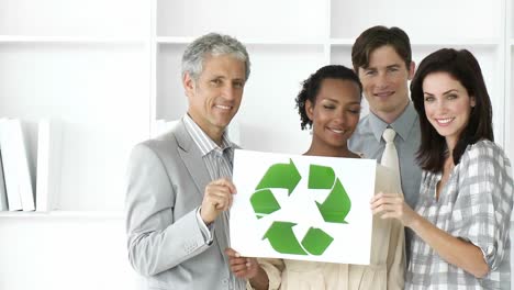 Enthusiastic-business-team-showing-the-concept-of-recycling