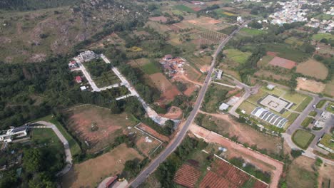 Aerial-footage-of-a-new-satellite-township-being-developed-near-Bangalore's-outskirts-demonstrates-how-agricultural-land-is-being-converted-to-urbanisation,-which-causes-deforestation