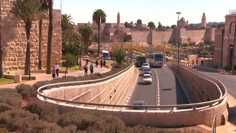 traffic moves near the old city walls of jerusalem israel