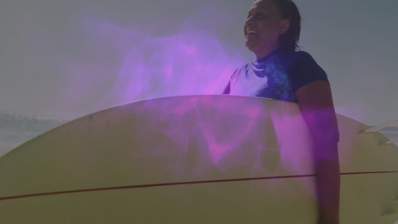 woman surfer holding surfboard on sandy beach, showing health icons floating with purple lens flare