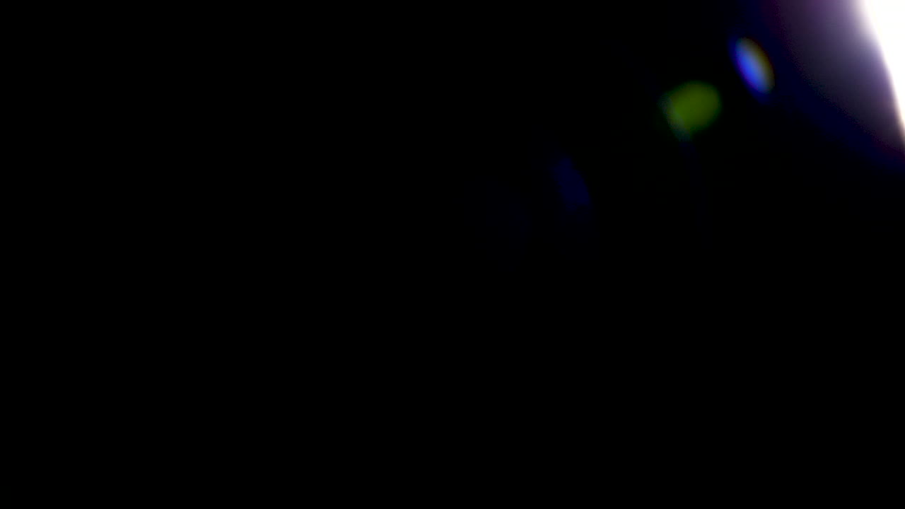 Organically captured lens flares warm type on black background