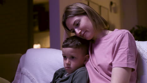 mother and son watching film