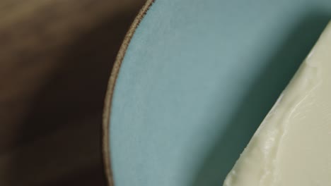 Close-up-shot-of-a-fresh-block-of-butter-lying-in-a-ceramic-bowl