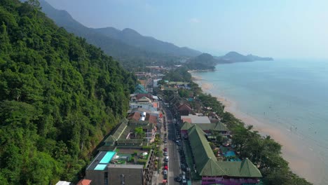 scenic aerial view of koh chang's beachfront and lush green hills. fantastic aerial view flight static tripod hovering drone