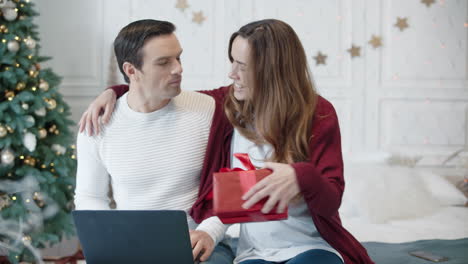 Surprised-man-getting-unexpected-present-in-modern-house.-Man-working-computer