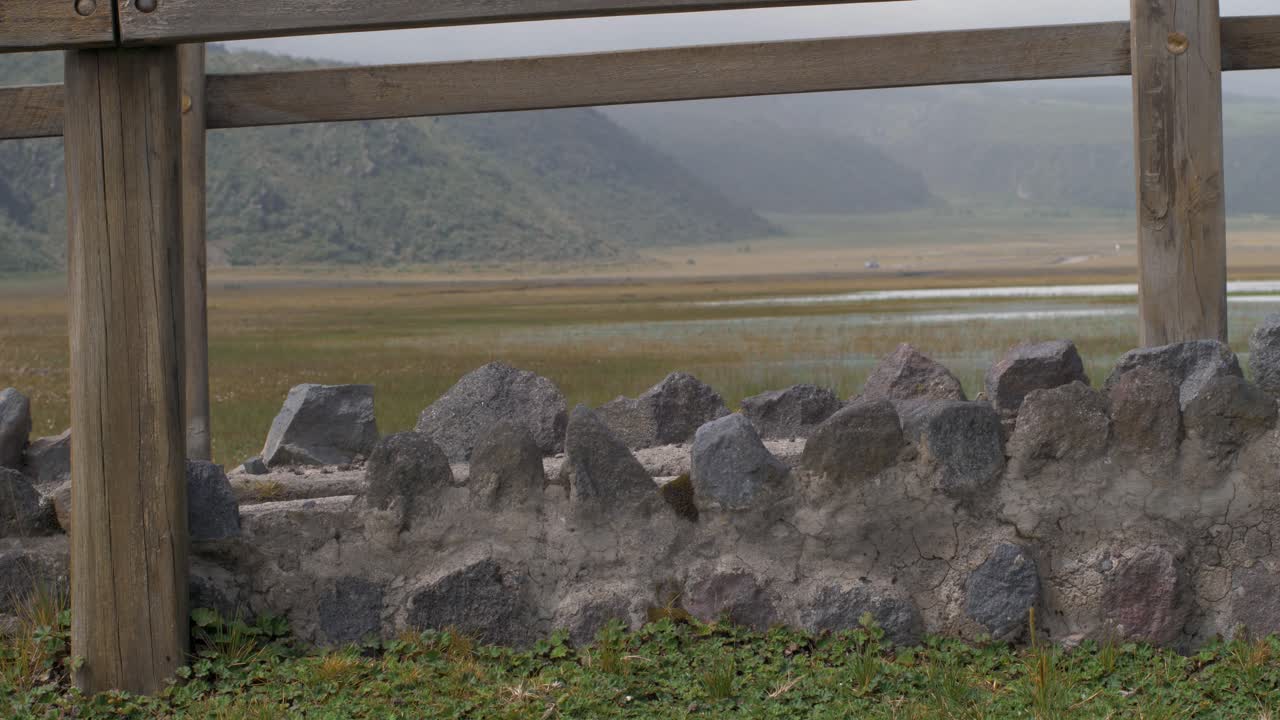 Medium view of girl in skirt wearing hiking boots walking across bridge in cotopaxi national park