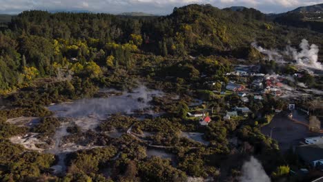 Beautiful-aerial-of-Whakarewarewa-living-Maori-village-and-geothermal-valley-Te-Puia,-Rotorua,-New-Zealand