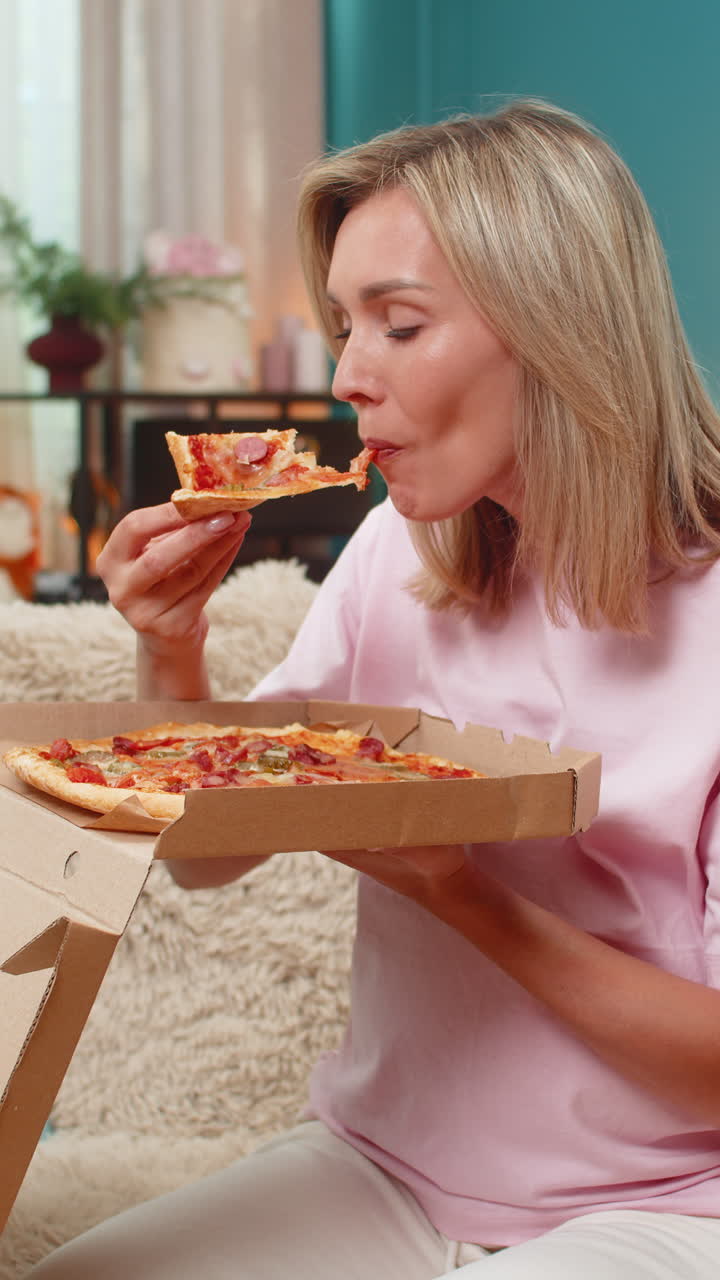 Pregnant woman opening pizza box inhaling hot aroma biting slice smiling enjoying delicious dinner
