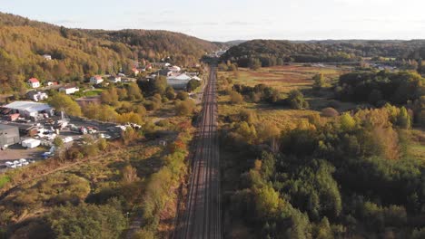 aerial wide angle pedestal shot of train railway tracks in sweden during the day