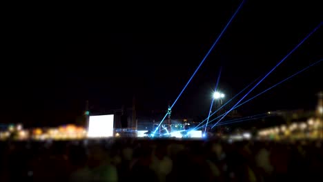 lights and laser performance at a concert and crowd, party people