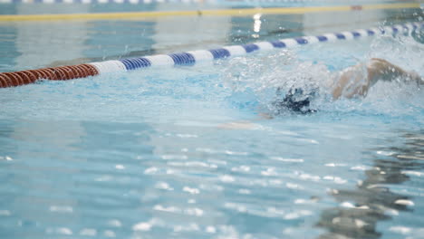 Slow-motion-shot-from-front-side-of-a-professional-female-swimmer-performing-front-crawl-during-training