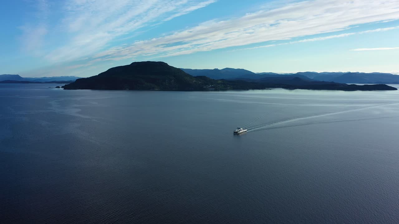 Electric ferry Ytterøyningen from Norled company distant aerial overview with beautiful coastline landscape in background - Ferry sailing towards Utbjoa Norway