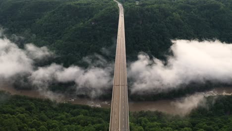 new river gorge bridge, aerial view of interstate route and clouds under arch