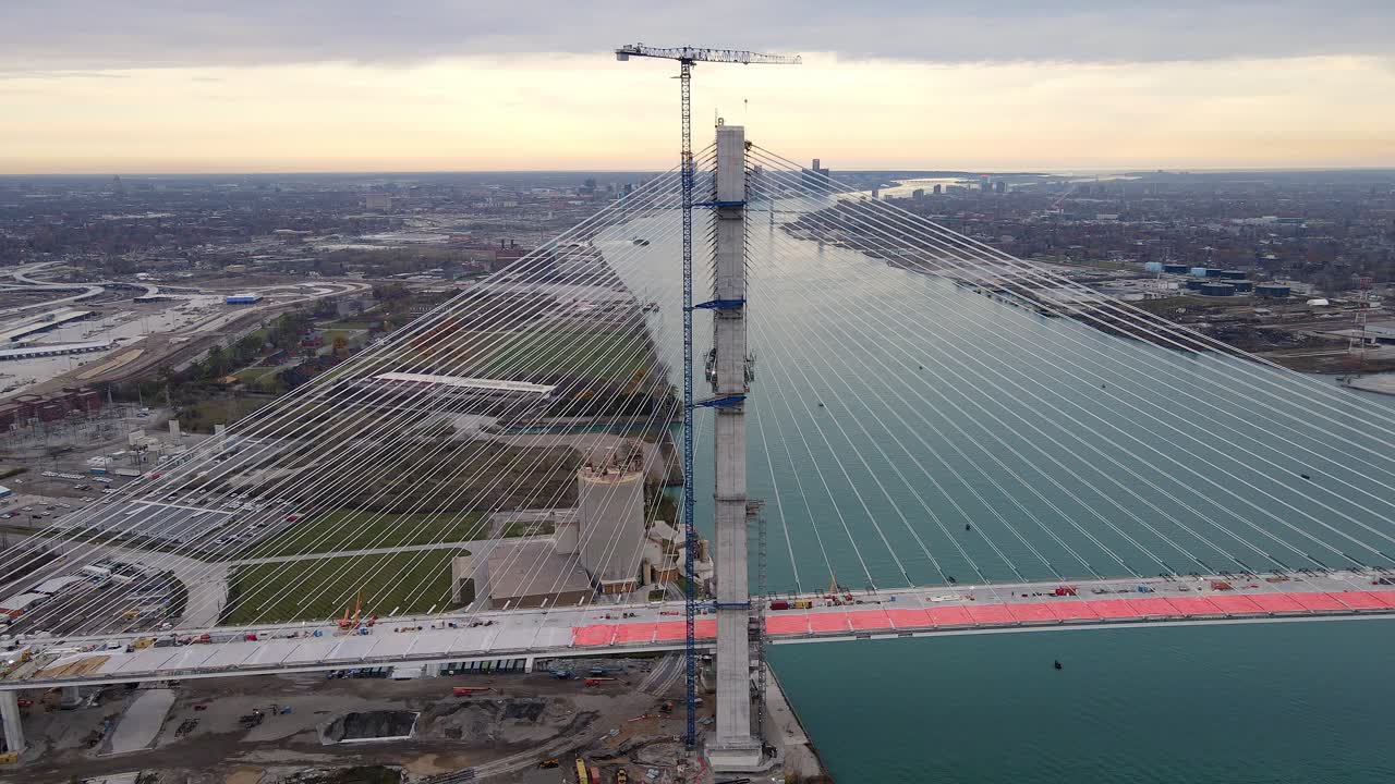 Gordie Howe International Bridge construction over Detroit River with Detroit skyline in background