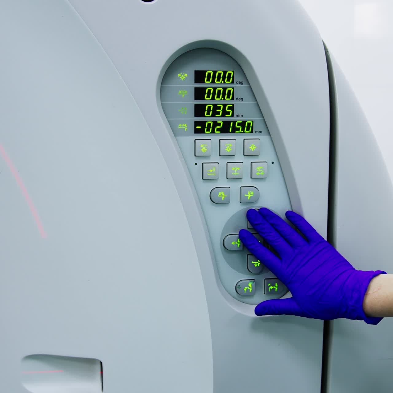 Gloved hand of medic setting the parameters on modern tomography scanner. Patient having a check up at the innovative equipment. Close up
