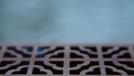 a detailed close-up macro shot of smoking incense in a wooden box, spiritual ritual meditation, scented therapy fragrance, relaxing aromatic white smoke, textured case, cinematic 4k video tilt up