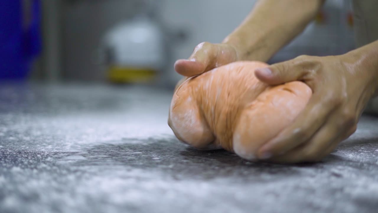 Chef preparing dough ontop of a table