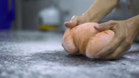 Chef-preparing-dough-ontop-of-a-table