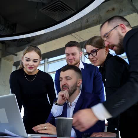 team of entrepreneurs working together. group of business partners work on a laptop and discuss new project in office room