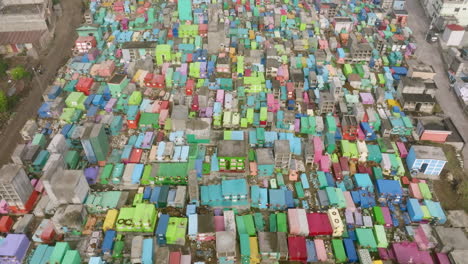 Wide-aerial-flyover-of-the-colorful-mausoleums-in-a-cemetery-in-San-Juan-Ostuncalco