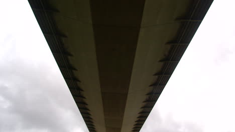 wide shot, tilting down from the bridge deck of the humber bridge on the south shore