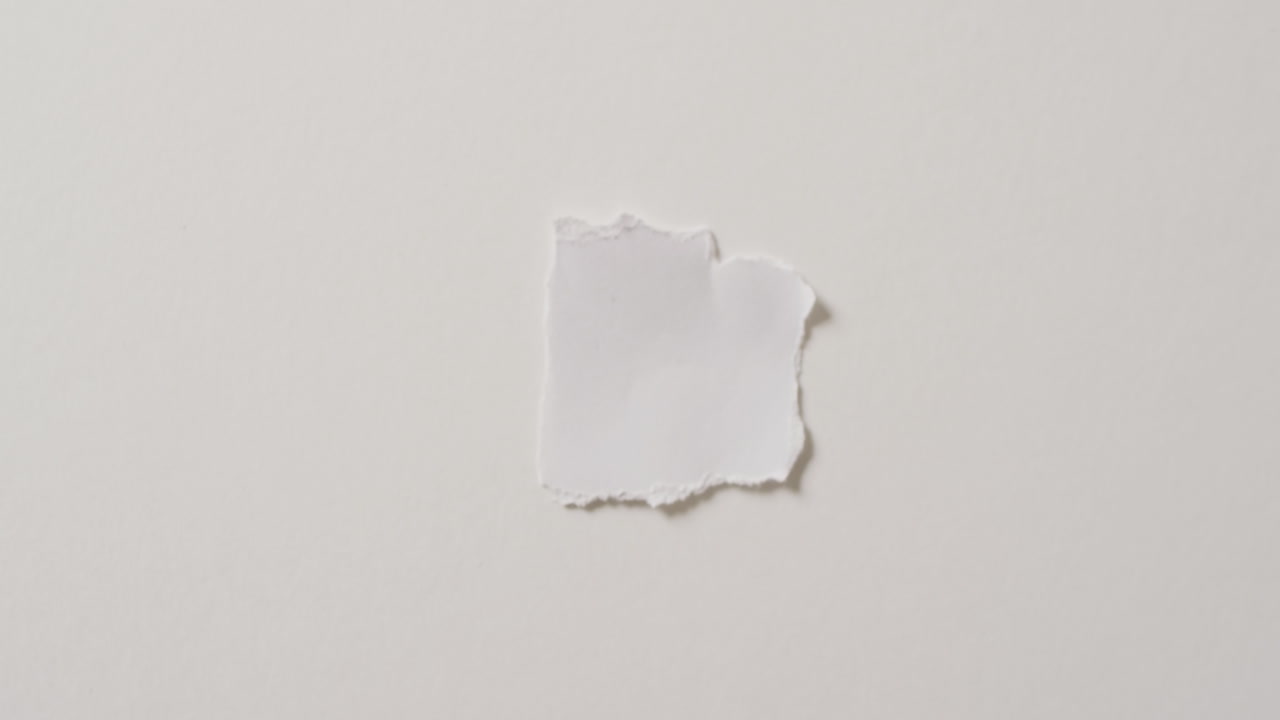 Video of close up of torn piece of paper with copy space on white background