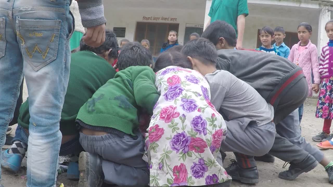 Manali, India, circa 2019 - Young students learn to pick up plastic, in the Himalayas